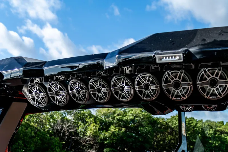 Slide: The Image of Rooftop speakers on AMP 333 model, 2026, under a clear blue sky. - 33