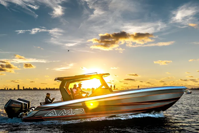 Slide: The Image of Modern AMP 333 boat cruising at sunset, 2026 model, with city skyline in background. - 4