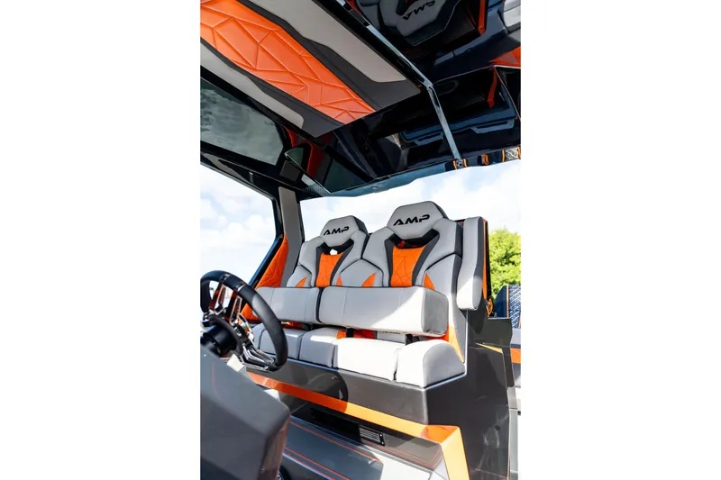 Slide: The Image of Interior of 2026 AMP 333 boat with modern orange and gray seating. - 47