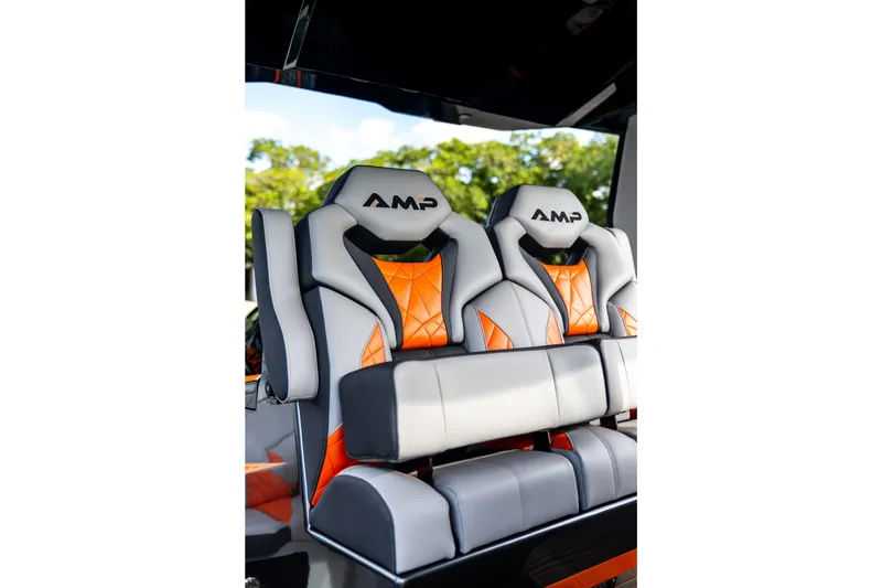 Slide: The Image of Luxury AMP 333 boat seats, 2026 model, featuring gray and orange design with logo. - 57