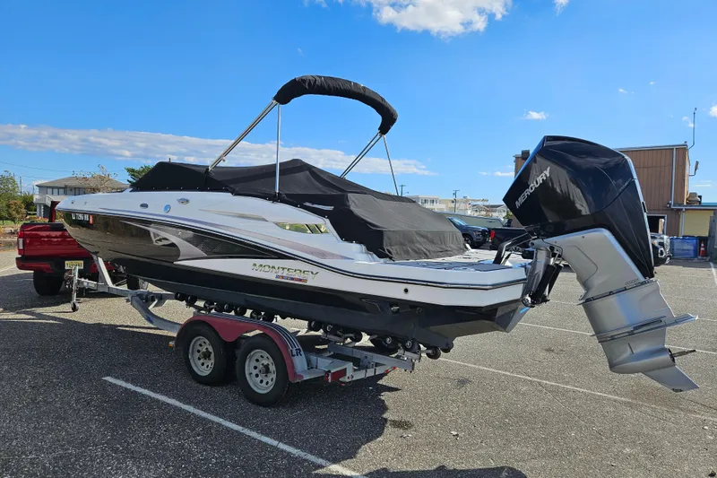 Slide: The Image of 2022 Monterey M-45 boat on trailer with Mercury outboard engine in parking lot. - 4