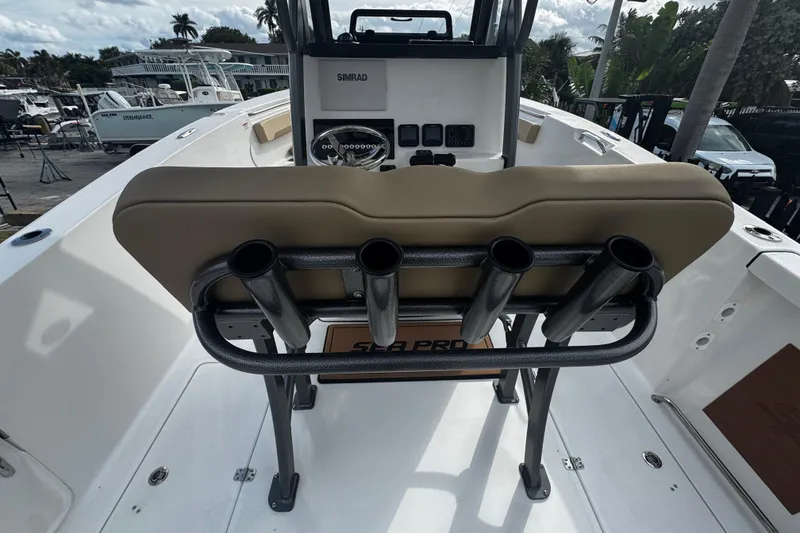Slide: The Image of 2026 Sea Pro 262 Offshore boat interior with rod holders and helm station. - 15