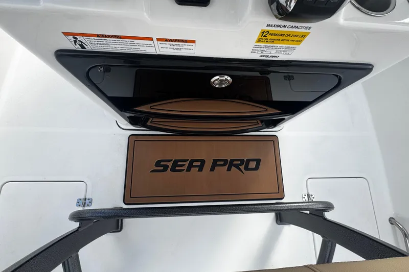 Slide: The Image of 2026 Sea Pro 262 Offshore boat interior with logo and capacity warning label. - 17