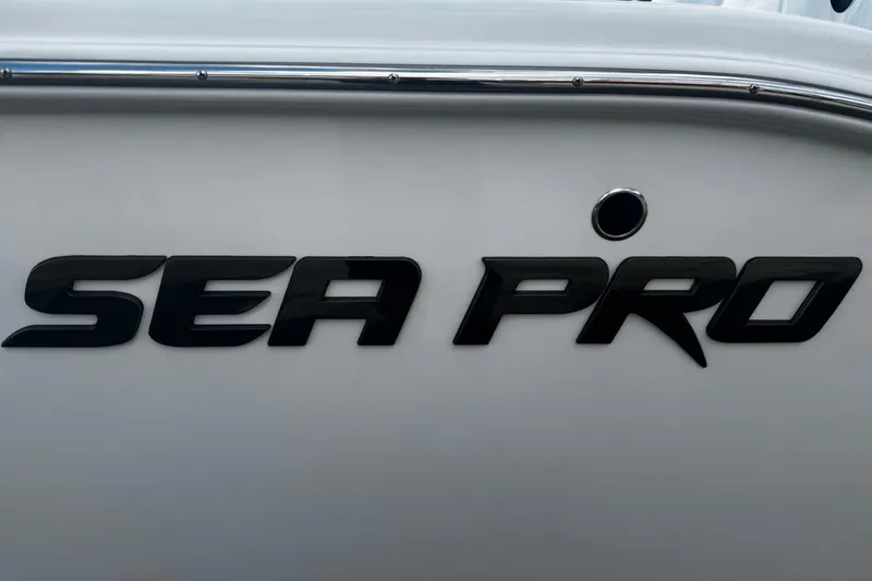 Slide: The Image of 2026 Sea Pro 262 Offshore boat logo on white hull. - 2