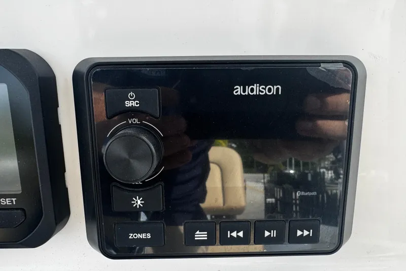 Slide: The Image of Audison audio control panel on 2026 Sea Pro 262 Offshore boat dashboard. - 23