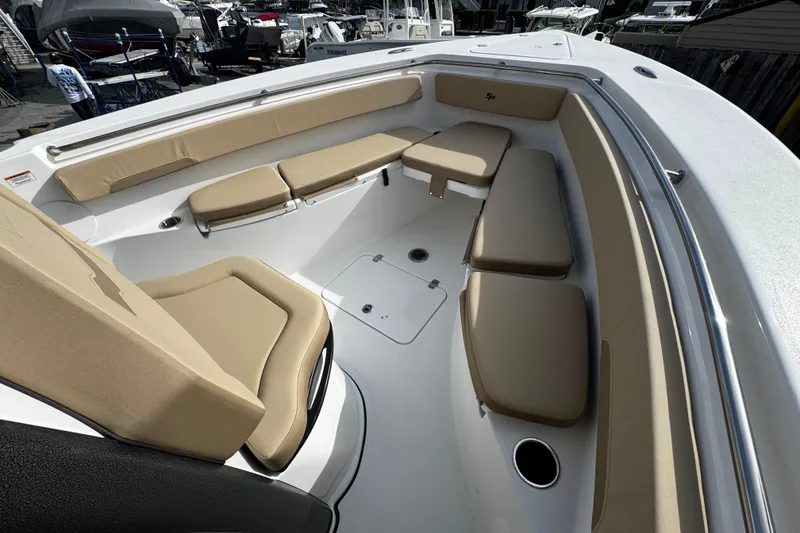 Slide: The Image of 2026 Sea Pro 262 Offshore boat interior with tan cushioned seating. - 31