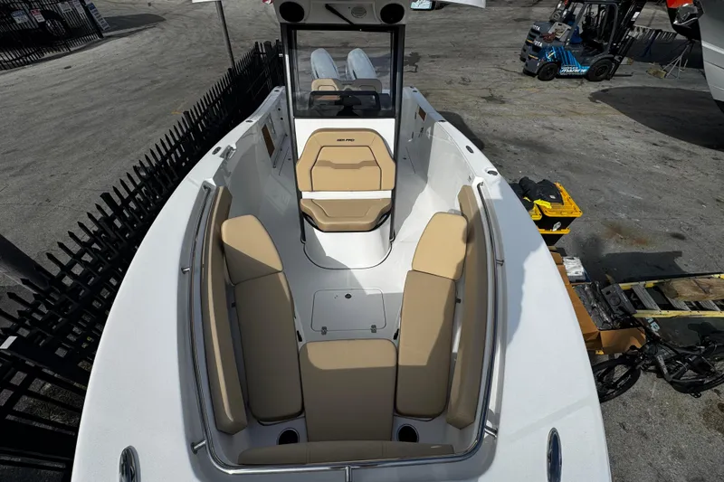 Slide: The Image of 2026 Sea Pro 262 Offshore boat with beige seating, docked in a marina. - 32