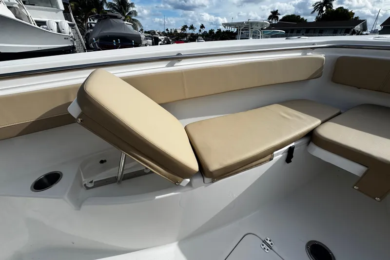 Slide: The Image of 2026 Sea Pro 262 Offshore boat interior with adjustable tan seating and cup holder. - 33