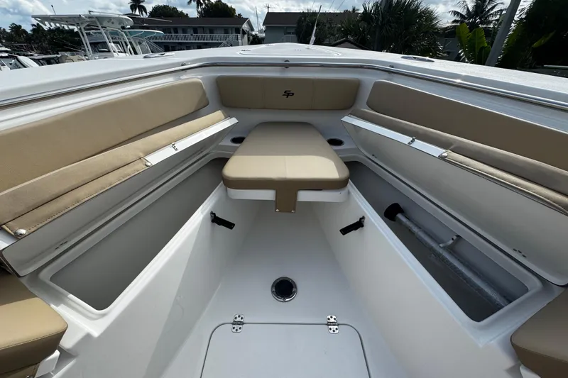 Slide: The Image of 2026 Sea Pro 262 Offshore boat interior with beige seating and storage compartments. - 35