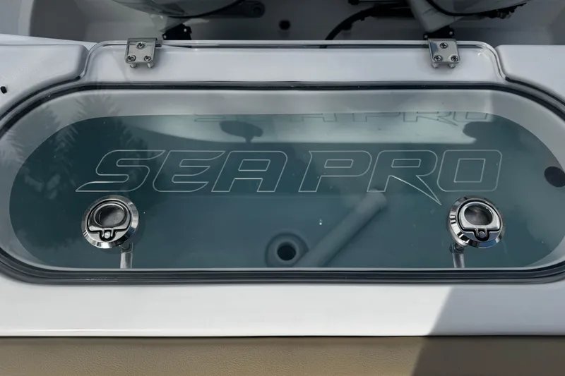 Slide: The Image of 2026 Sea Pro 262 Offshore livewell with logo and stainless steel fittings. - 4