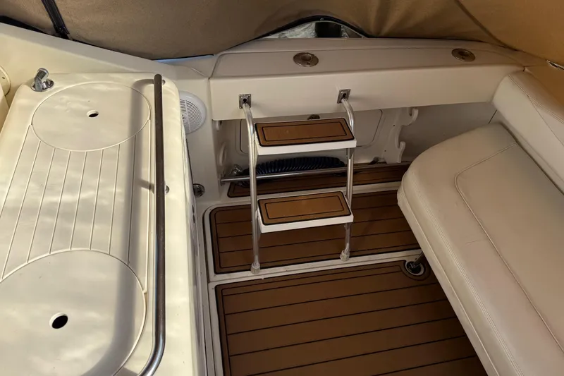 Slide: The Image of 2005 Sea Ray 290 Amberjack interior with ladder and seating area. - 10