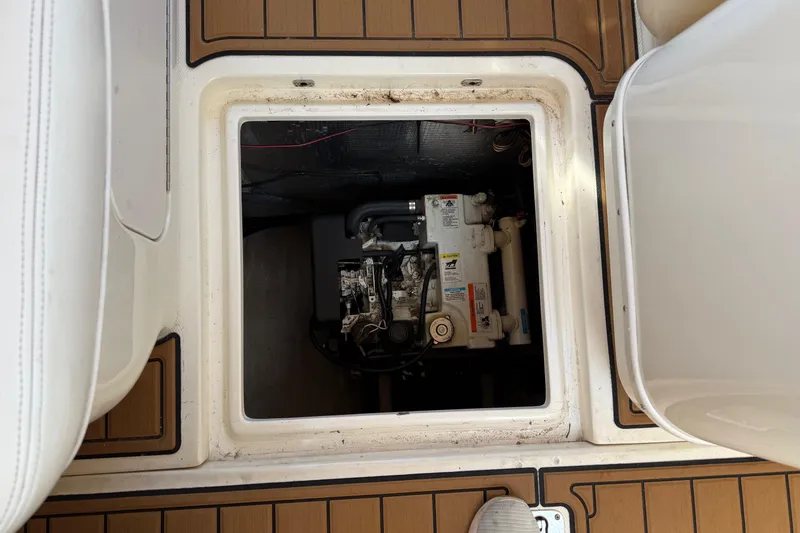 Slide: The Image of Engine compartment of 2005 Sea Ray 290 Amberjack boat, showcasing mechanical components. - 13