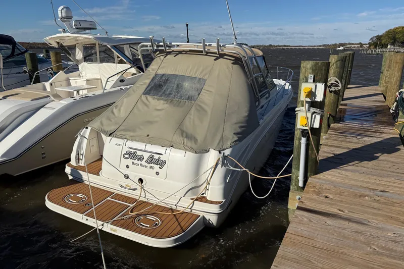 The Image of 2005 Sea Ray 290 Amberjack docked at marina with covered deck. - 2