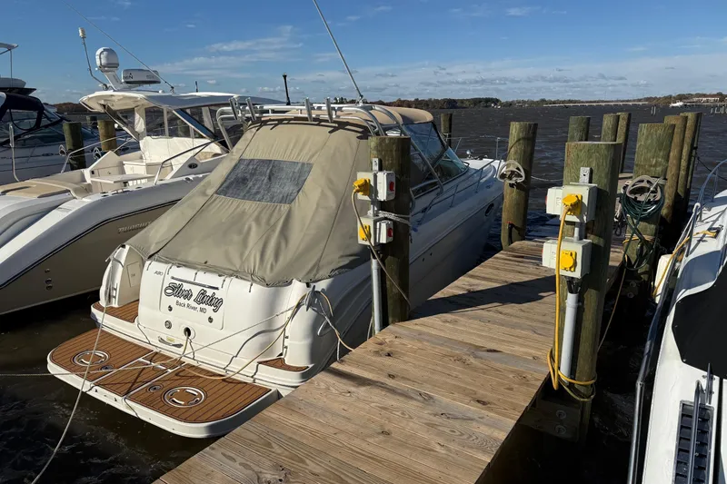 Slide: The Image of 2005 Sea Ray 290 Amberjack docked at a marina with a covered deck. - 5