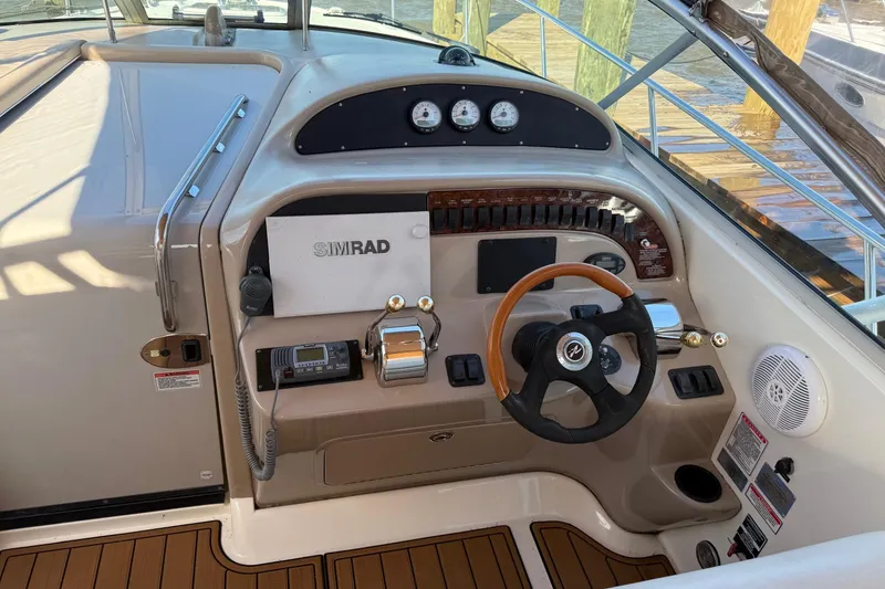 Slide: The Image of 2005 Sea Ray 290 Amberjack helm with Simrad electronics and wooden steering wheel. - 7