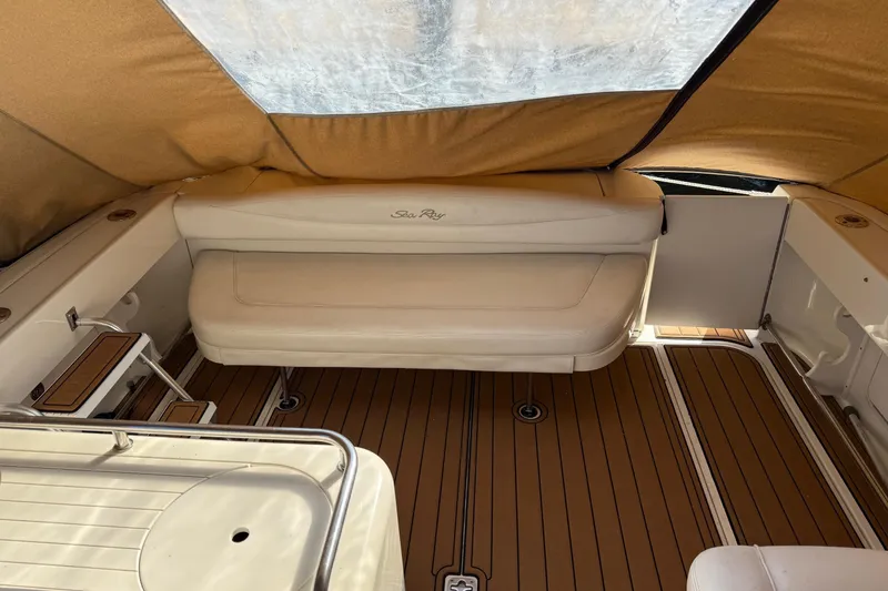 Slide: The Image of 2005 Sea Ray 290 Amberjack interior with tan seating and wood flooring. - 9