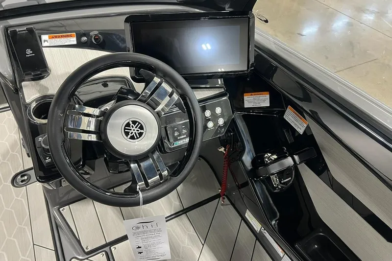 Slide: The Image of 2025 Yamaha Boats 222XD dashboard with steering wheel and touchscreen display. - 6