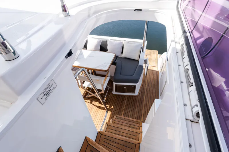 Slide: The Image of 2023 Azimut Fly 50 yacht with elegant wooden deck and comfortable seating area. - 32