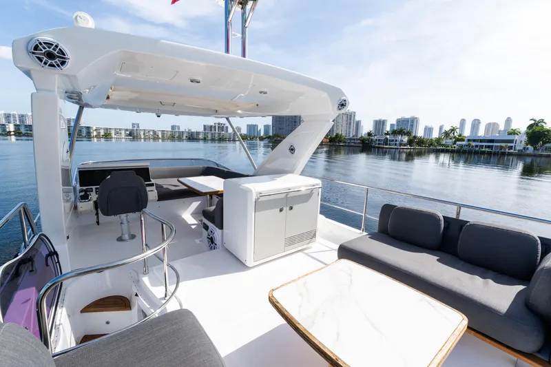 Slide: The Image of Luxurious 2023 Azimut Fly 50 yacht deck with modern seating and scenic waterfront view. - 33