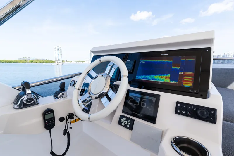 Slide: The Image of 2023 Azimut Fly 50 yacht helm with advanced navigation displays and controls. - 46
