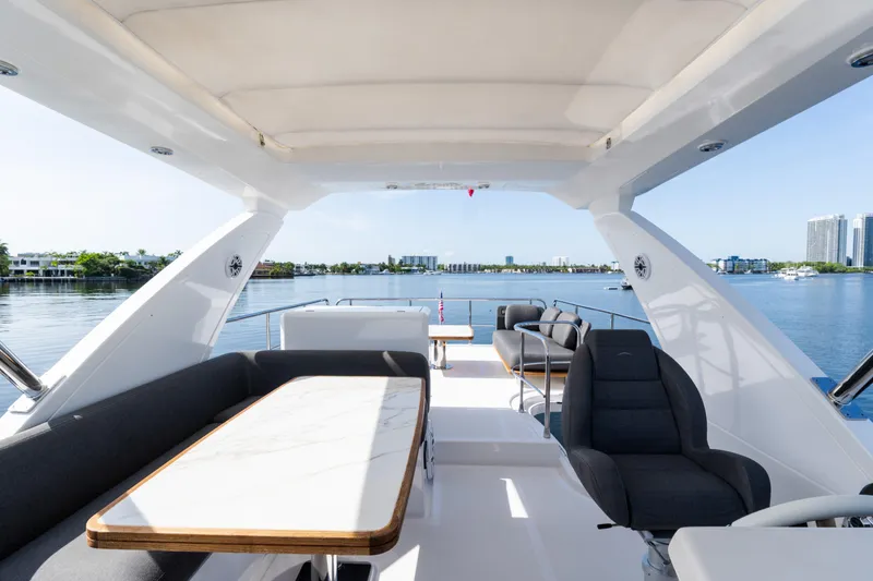 Slide: The Image of Luxurious 2023 Azimut Fly 50 yacht interior with elegant seating and scenic waterfront view. - 52