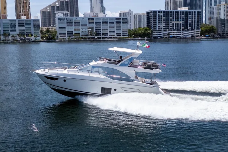 Slide: The Image of 2023 Azimut Fly 50 yacht cruising near city skyline on a sunny day. - 7