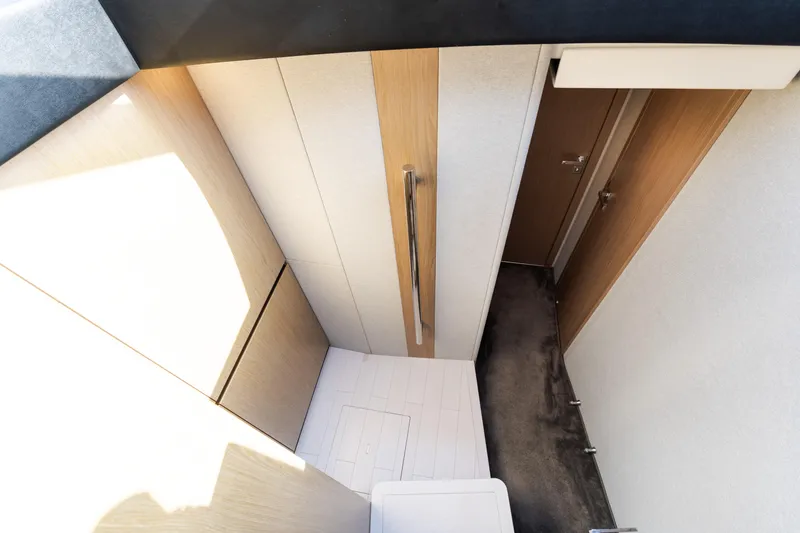 Slide: The Image of Interior view of 2023 Azimut Fly 50 yacht, featuring modern wood paneling and sleek design. - 82