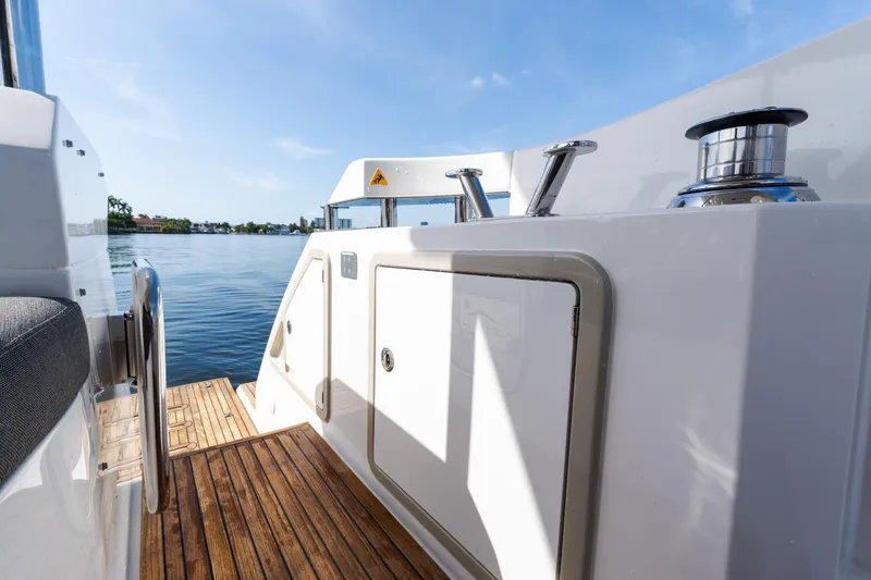 Slide: The Image of 2023 Azimut Fly 50 yacht deck with wooden flooring and water view. - 112