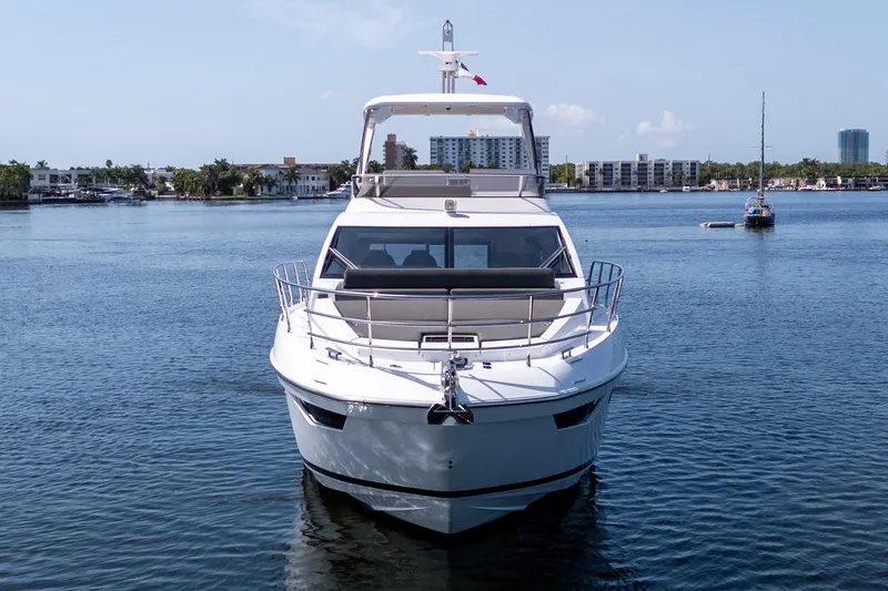 Slide: The Image of 2023 Azimut Fly 50 yacht on calm water, cityscape in background. - 15