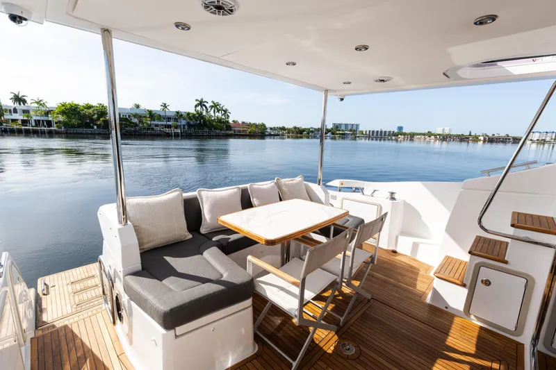 Slide: The Image of Luxurious 2023 Azimut Fly 50 yacht deck with seating, overlooking serene waterfront views. - 18