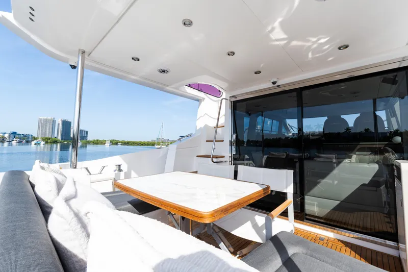 Slide: The Image of Luxurious 2023 Azimut Fly 50 yacht deck with seating and scenic waterfront view. - 21