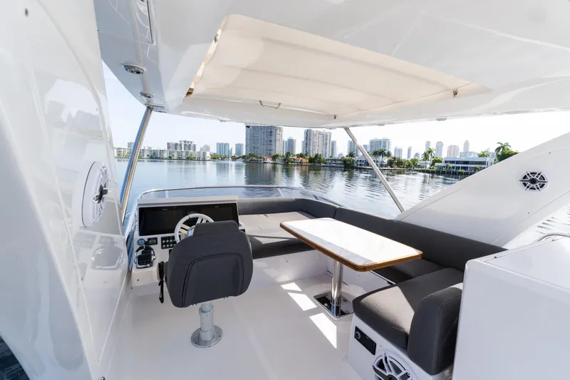 Slide: The Image of 2023 Azimut Fly 50 yacht interior with helm, seating, and table overlooking waterfront skyline. - 42