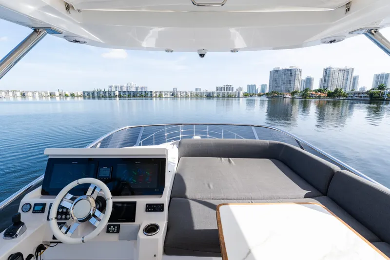 Slide: The Image of 2023 Azimut Fly 50 yacht interior with city skyline view, featuring modern helm and seating area. - 51