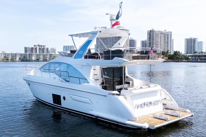 Slide: The Image of 2023 Azimut Fly 50 yacht on water with city skyline backdrop. - 6