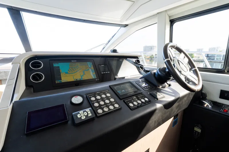 Slide: The Image of 2023 Azimut Fly 50 yacht cockpit with advanced navigation controls and steering wheel. - 77