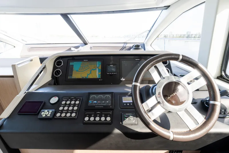 Slide: The Image of 2023 Azimut Fly 50 yacht helm with navigation controls and steering wheel. - 78