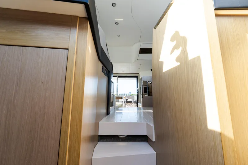 Slide: The Image of Interior view of 2023 Azimut Fly 50 yacht, featuring sleek wooden finishes and modern design. - 84