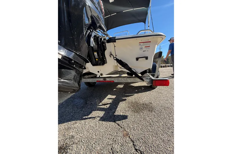 Slide: The Image of 2024 Mako Pro Skiff 15 CC boat on trailer, parked outdoors under clear sky. - 5