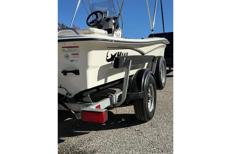 Slide: The Image of 2024 Mako Pro Skiff 15 CC on trailer, rear view, sunny day. - 6