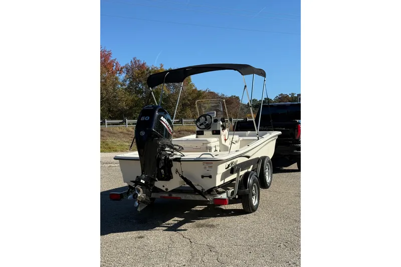 Slide: The Image of 2024 Mako Pro Skiff 15 CC boat on trailer, parked outdoors. - 7