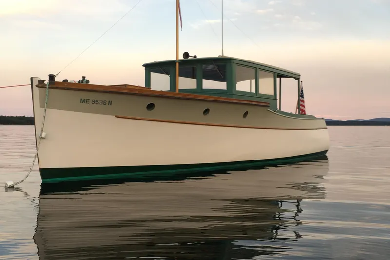 Slide: The Image of 1929 Classic Lobster Cruiser on calm water at sunset. - 1
