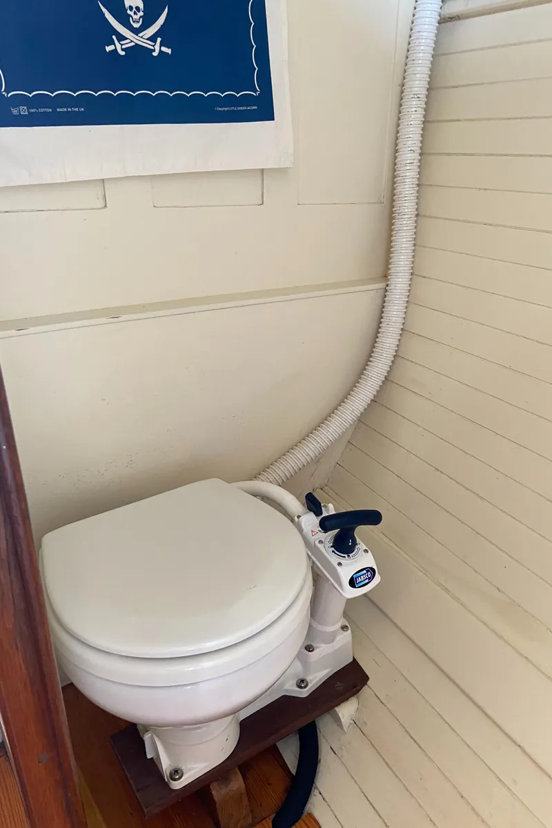 Slide: The Image of 1929 Classic Lobster Cruiser marine toilet with pirate-themed decor. - 13