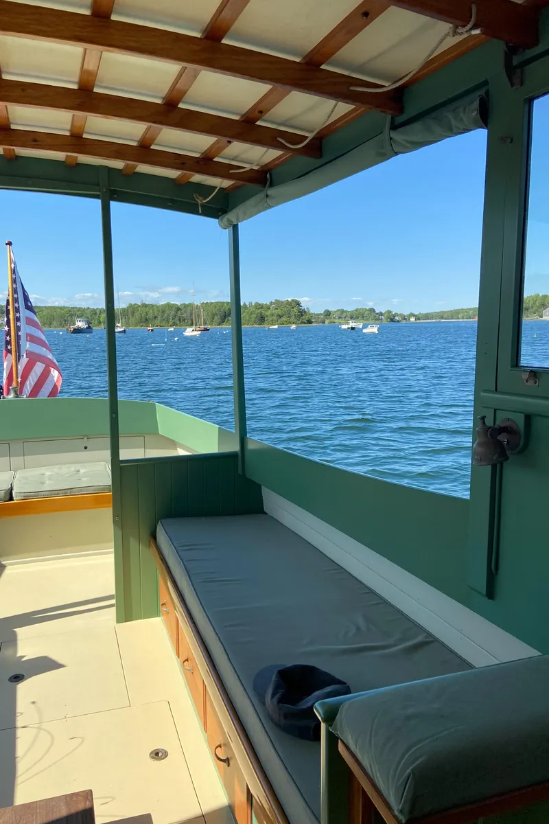 Slide: The Image of 1929 Classic Lobster Cruiser interior with lake view and American flag. - 14
