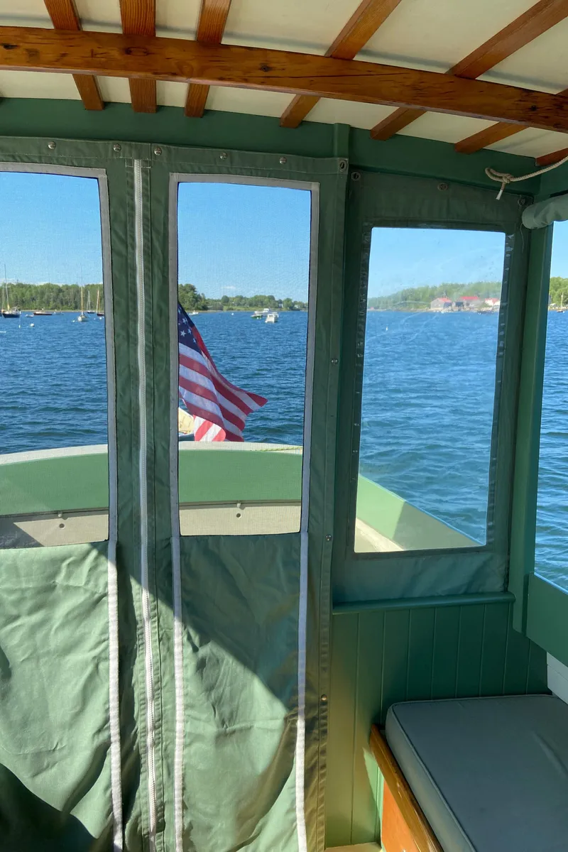 Slide: The Image of Interior view of a 1929 Classic Lobster Cruiser with an American flag on a sunny day. - 16