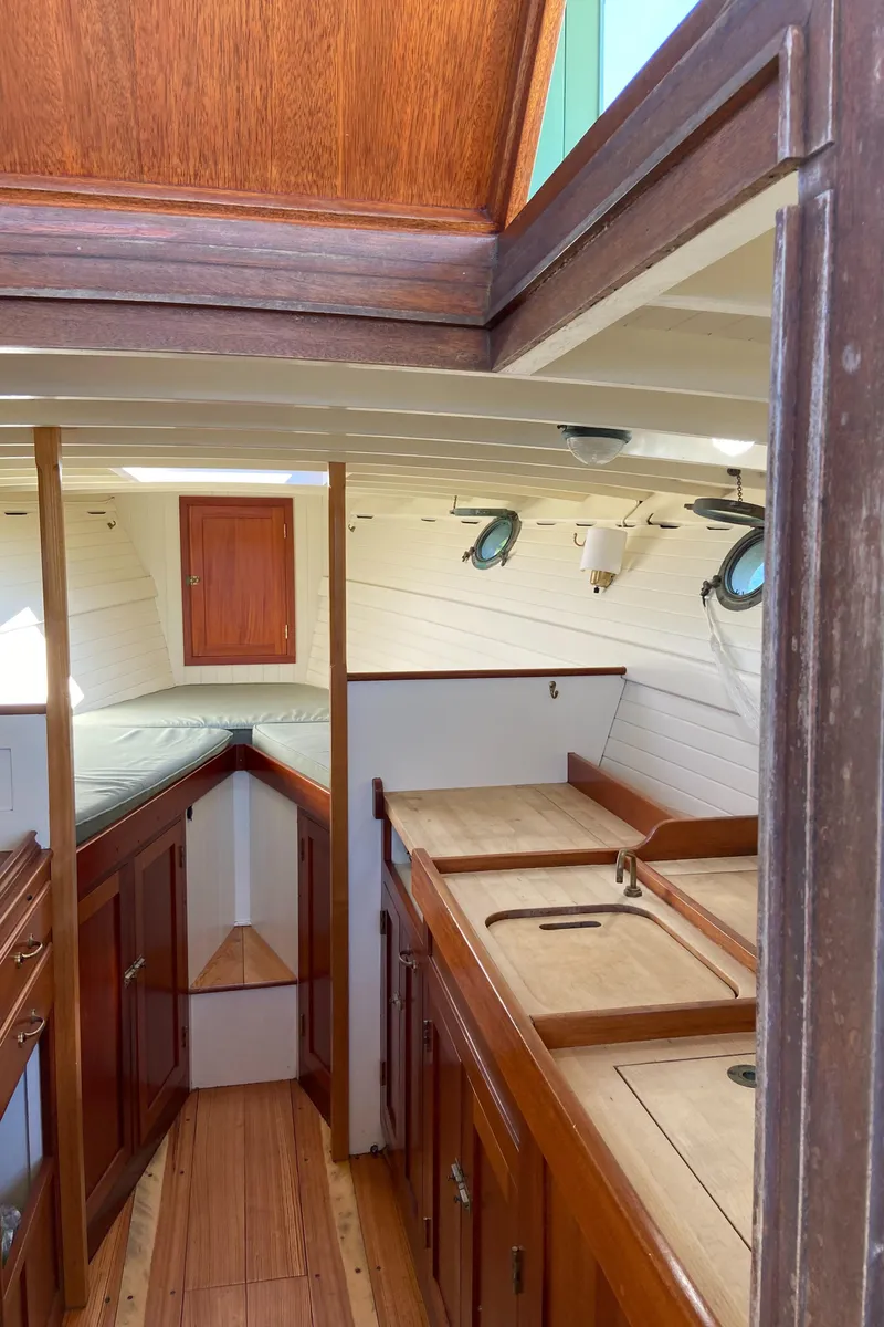 Slide: The Image of Interior of a 1929 Classic Lobster Cruiser with wooden cabinetry and nautical design. - 18