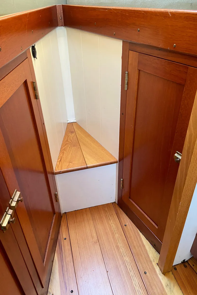 Slide: The Image of 1929 Classic Lobster Cruiser interior with polished wood paneling and corner storage. - 20