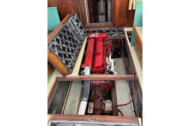 Slide: The Image of Engine compartment of a 1929 Classic Lobster Cruiser with red engine and wooden interior. - 23