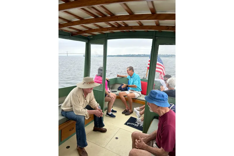 Slide: The Image of People enjoying a ride on a 1929 Classic Lobster Cruiser boat. - 25