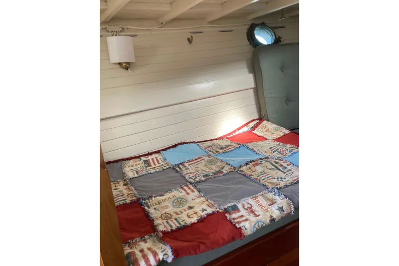Slide: The Image of Cozy cabin interior of 1929 Classic Lobster Cruiser with nautical-themed quilt. - 29