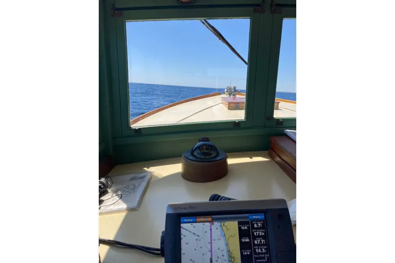 Slide: The Image of 1929 Classic Lobster Cruiser cockpit view with navigation equipment and ocean horizon. - 30